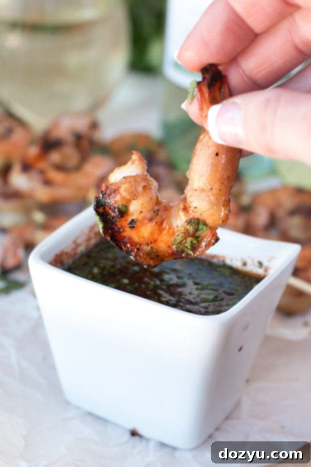 Zesty Mango Garlic Shrimp Skewers with Spicy Cilantro Dip 5 Mango and garlic marinated raw shrimp on skewers, awaiting the grill to transform them into a delicious summer appetizer. | cakenknife.com #21andup @CavitWines