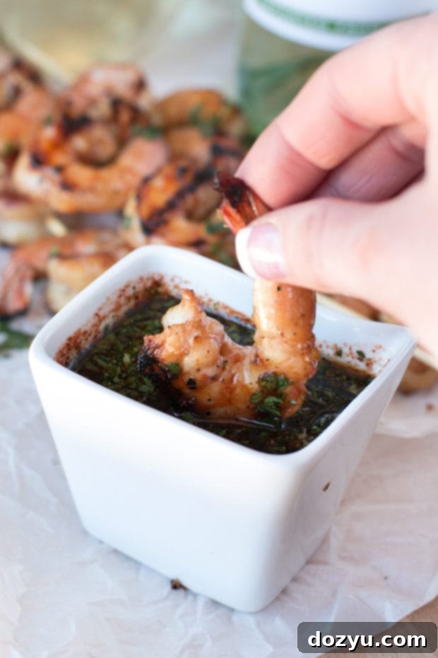 Zesty Mango Garlic Shrimp Skewers with Spicy Cilantro Dip 6 A glass of chilled Cavit Pinot Grigio next to a plate of Mango Garlic Shrimp Skewers, a perfect wine pairing for a summer evening. | cakenknife.com #21andup @CavitWines