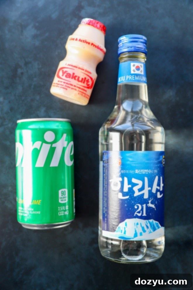Soju Yogurt Delight 3 Soju yogurt cocktail ingredients laid out: a green bottle of Soju, a small white bottle of Yakult drinkable yogurt, and a can of Sprite soda, ready for mixing