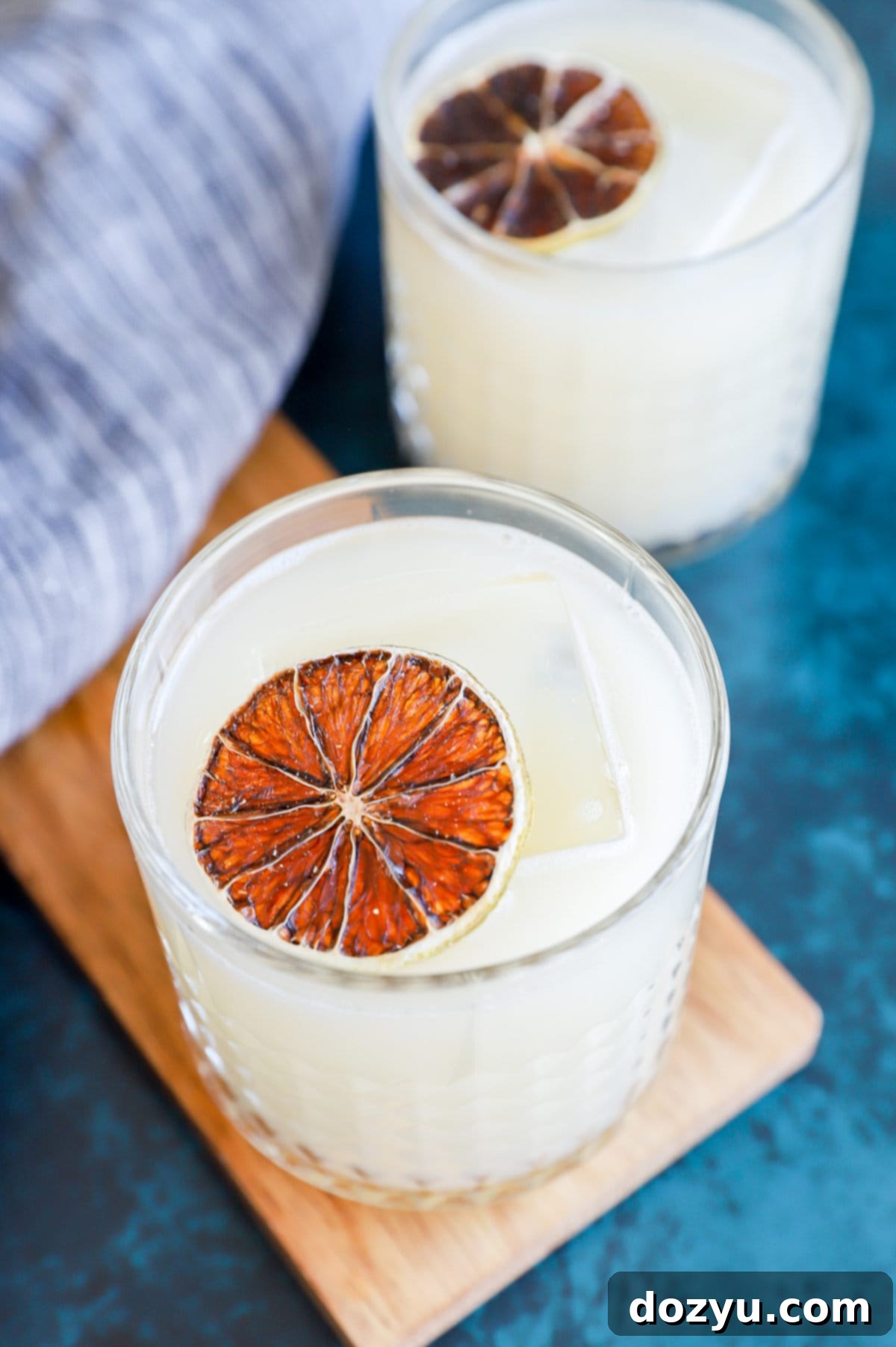 Soju Yogurt Delight 9 Easy Soju Yogurt Cocktail with a creamy texture in an elegant glass with ice and lemon garnish