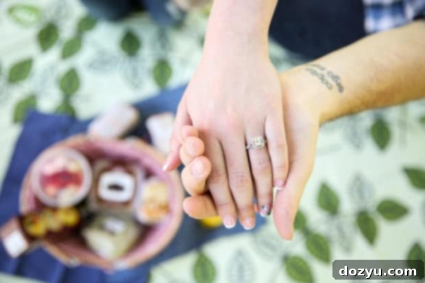 Newly engaged couple celebrating with a kiss during their picnic