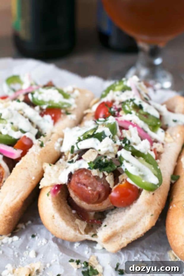 Kickin' Bacon-Wrapped Brats & Zesty Pickled Red Onions 6 A perfectly grilled Spicy Bacon-Wrapped Bratwurst, showcasing the crispy bacon and colorful toppings including pickled red onions and fresh jalapeños | cakenknife.com #bratwurst #hotdog #summer #bacon