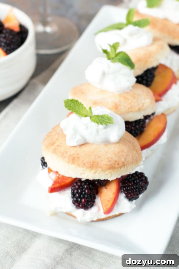 Arranged Blackberry Peach Shortcake Stacks with fresh mint garnish, ready to serve.