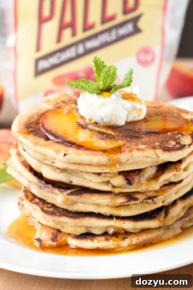 Golden Peach Pancakes with Whipped Mint Butter 2 Delicious caramelized peach pancakes served with fluffy whipped mint butter and sweet bourbon maple syrup, perfect for a summer brunch.