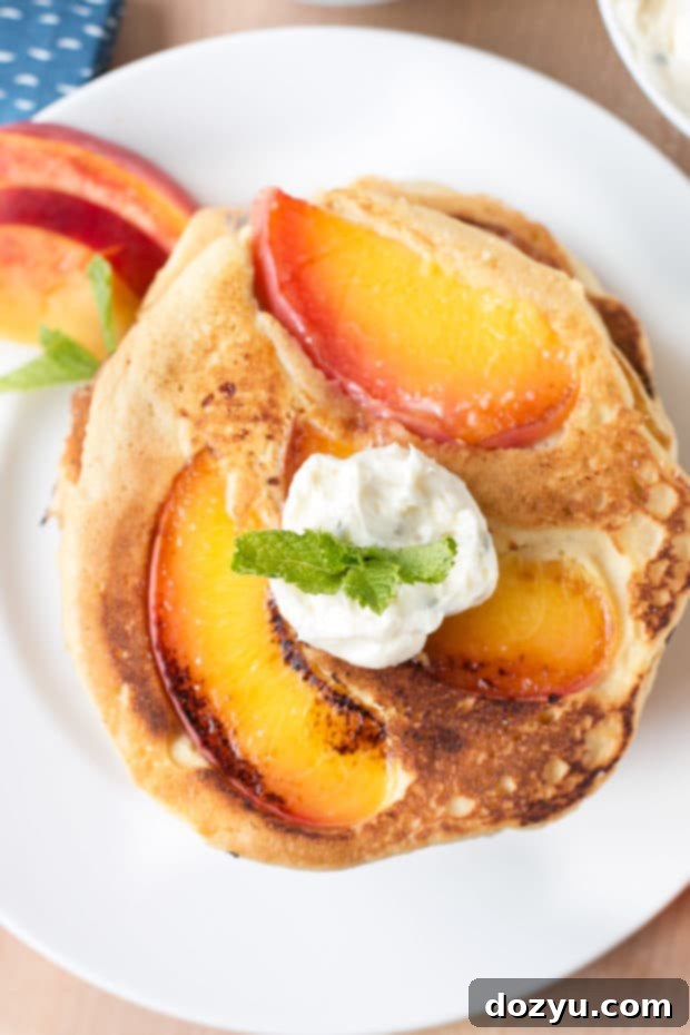 Golden Peach Pancakes with Whipped Mint Butter 3 Close-up of fluffy peach pancakes with golden caramelized edges, ideal for a wholesome, dietary-friendly breakfast or special occasion brunch.