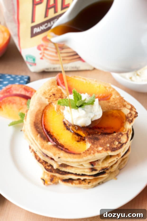Golden Peach Pancakes with Whipped Mint Butter 8 Overhead shot of peach pancakes arranged artfully on a plate, garnished with fresh mint and a drizzle of syrup, emphasizing the appealing presentation for any brunch.