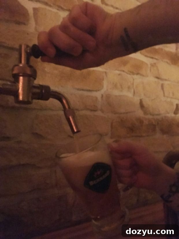 Relaxing in a wooden tub filled with beer spa ingredients and enjoying a pint