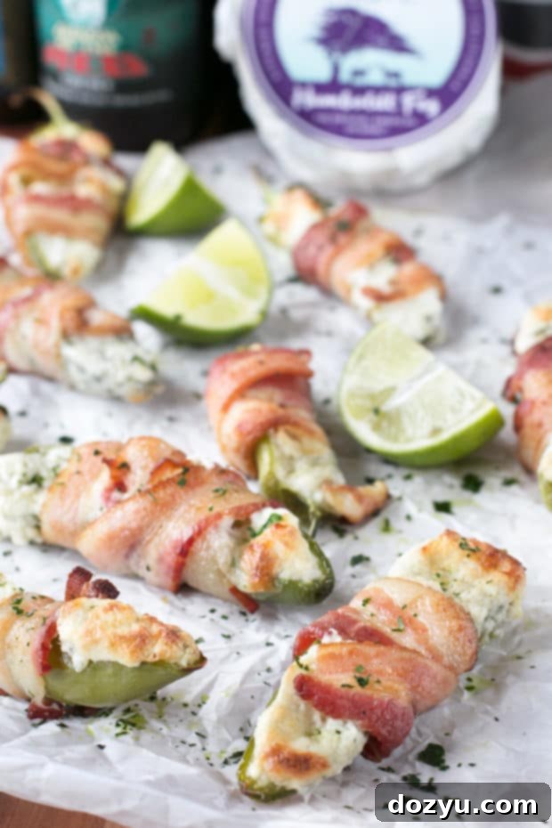 Close-up of crispy Bacon Wrapped Jalapeños stuffed with creamy goat cheese, ideal for tailgating.