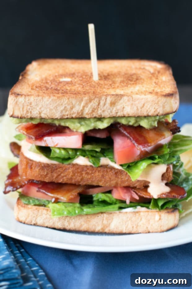 Blazing Bliss BLAT Tower 3 Close-up of a Double Decker BLAT showing the layers of bacon, lettuce, avocado, tomato, and fried bread. Ideal for a delicious homemade lunch. #lunch #sandwich #bacon #homemade