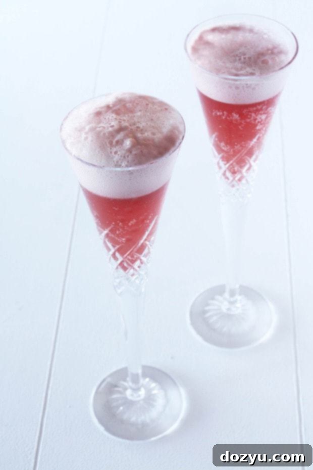Toast the New Year with Raspberry Sorbet and Champagne 2 A vibrant raspberry sorbet champagne cocktail in a flute, ready for a celebration.