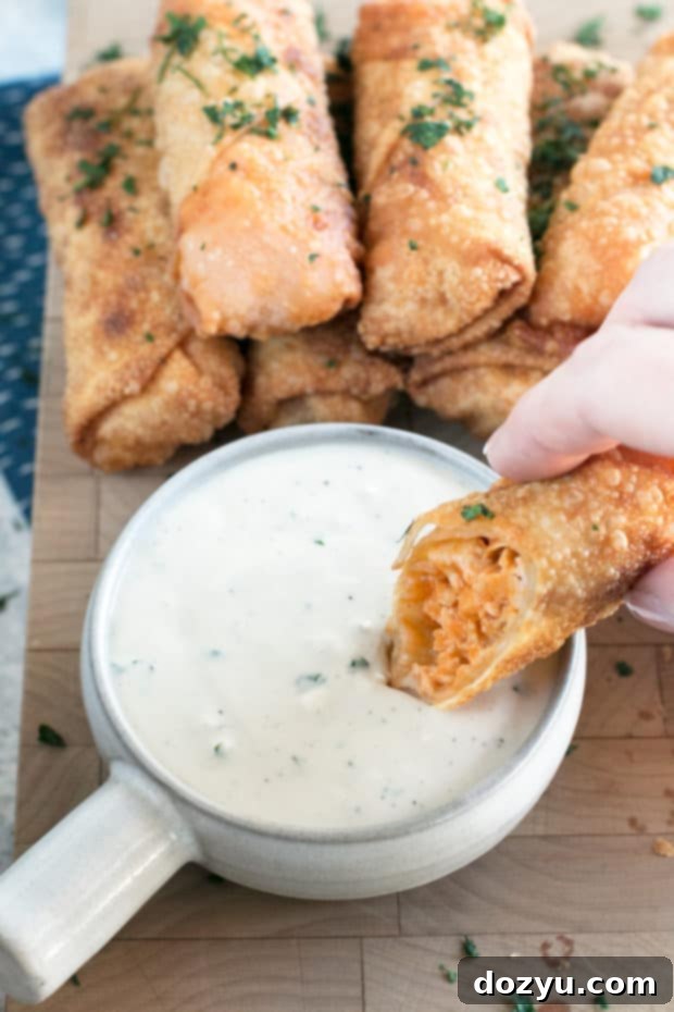 A plate of Blue Cheese Buffalo Chicken Egg Rolls with dipping sauce