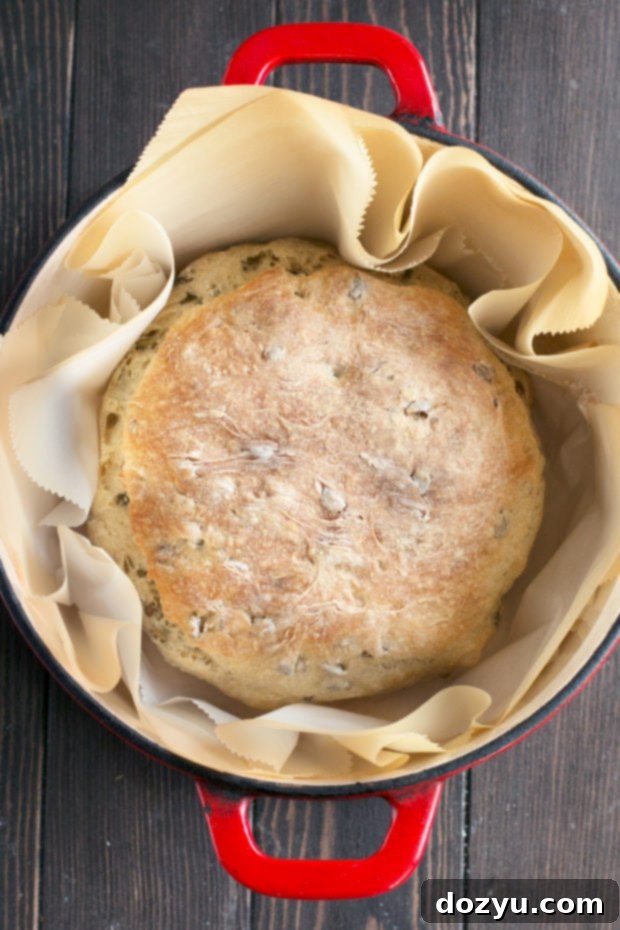 Close-up of a slice of Harvest Pumpkin Seed Bread showing the crunchy crust and airy interior