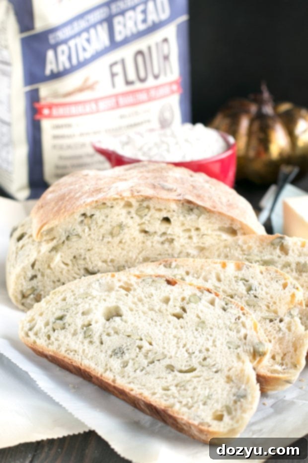 Top-down view of Harvest Pumpkin Seed Bread with a generous amount of pumpkin seeds