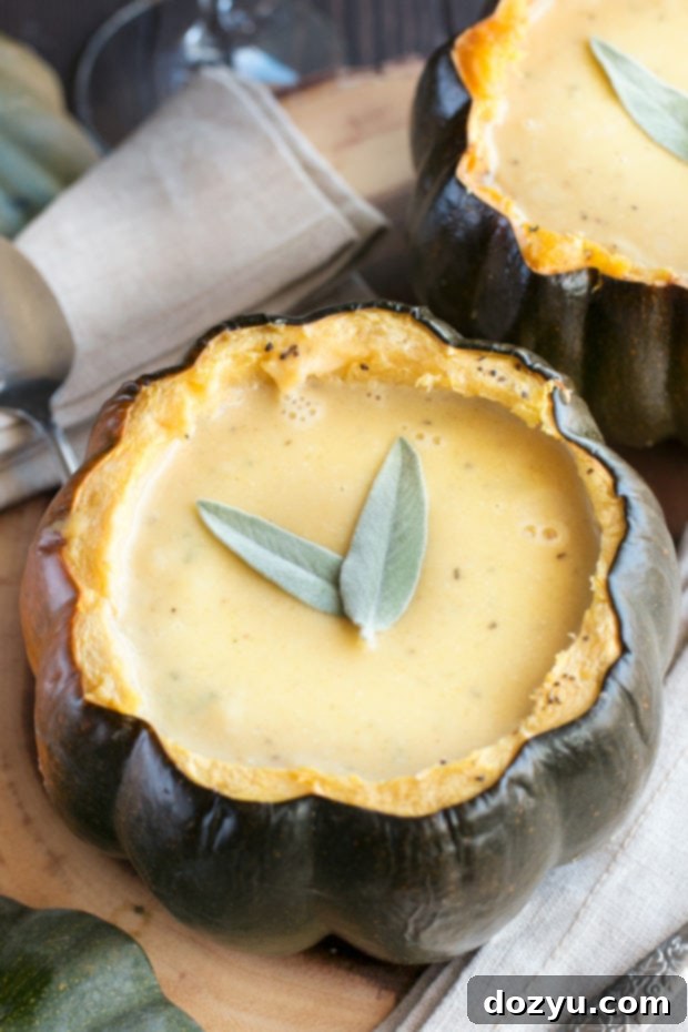 Close-up of Individual Ginger Acorn Squash Soup Bowls with a spoon, highlighting the creamy texture and inviting presentation.