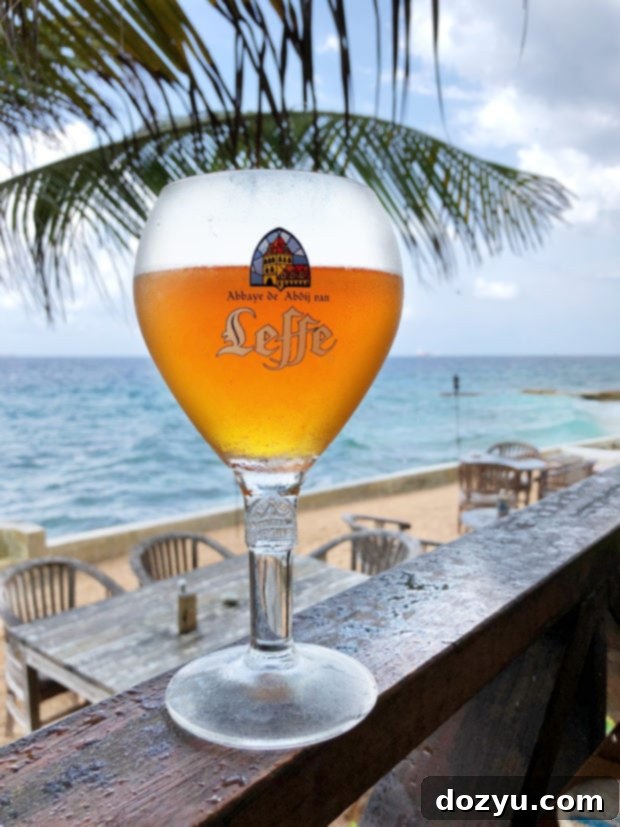 Enjoying Belgian beer with a scenic beach view in Curaçao