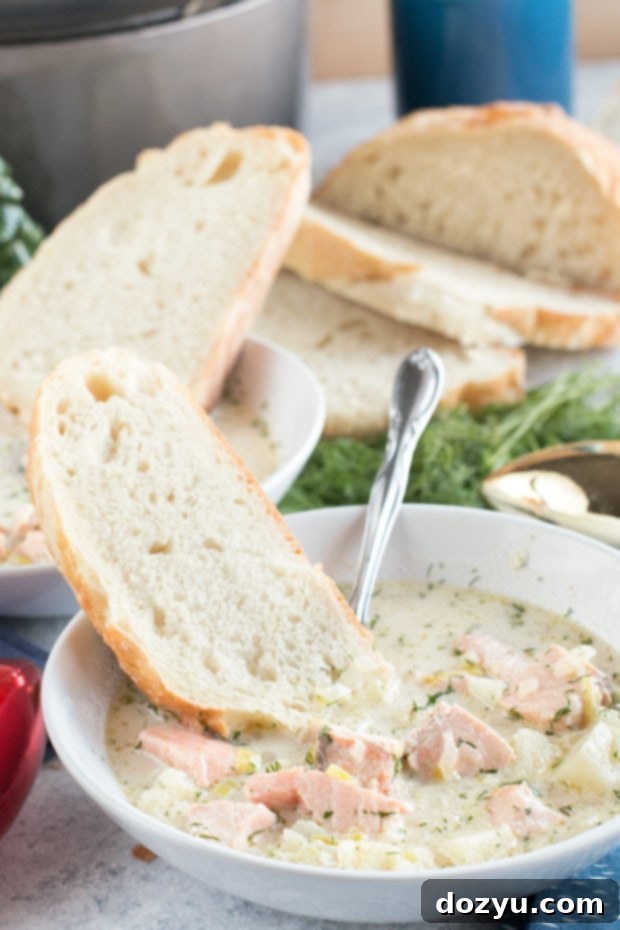 A bowl of creamy Salmon Chowder, garnished with fresh dill, ready to be enjoyed. #salmon #chowder #recipe #seafood #soup #christmas