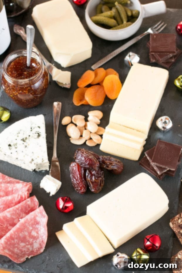 Very Merry Christmas Cheese Board | A beautifully arranged Christmas cheese board featuring a variety of cheeses, fruits, and crackers for holiday entertaining.