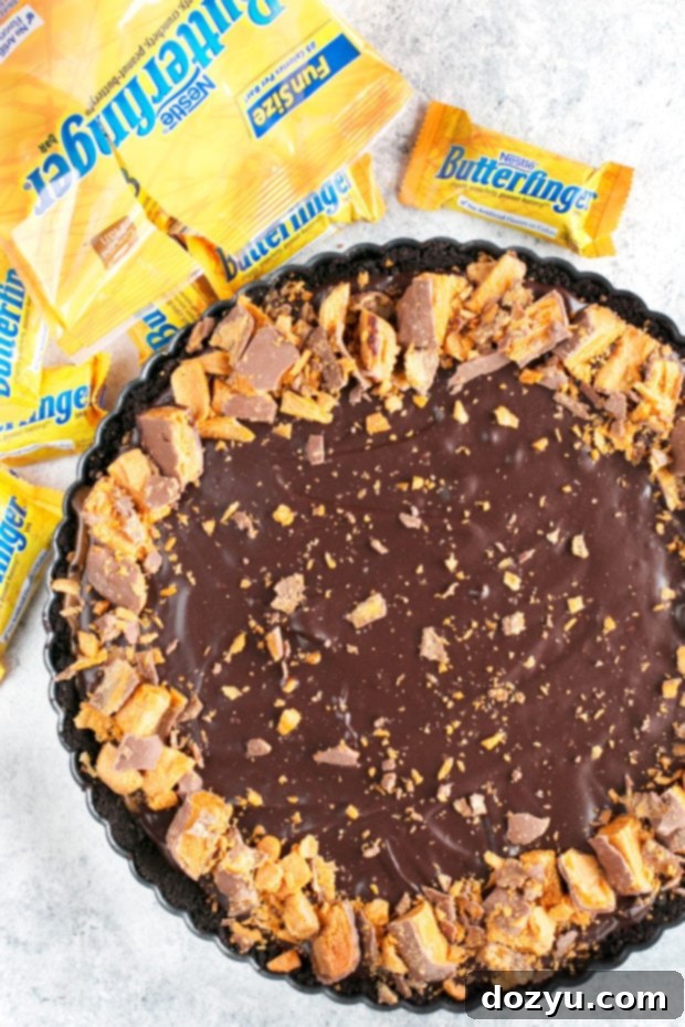Side view of the Butterfinger Caramel Ganache Tart showing the distinct layers