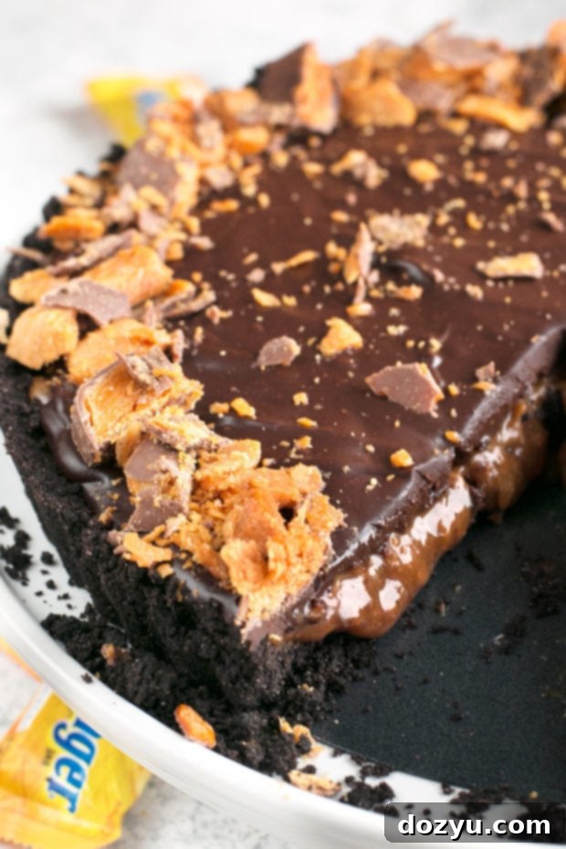 Close-up of the tart with a fork, highlighting the gooey caramel and ganache