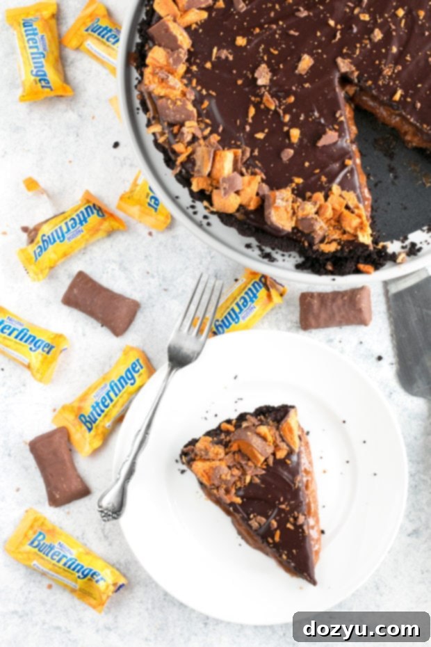 A large Butterfinger Caramel Ganache Tart on a wooden board