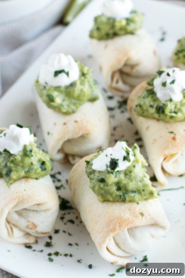Golden Baked Chimichanga Bites with Spicy Avocado Dip 6 Baked mini chimichangas on a plate with a side of creamy spicy guacamole.