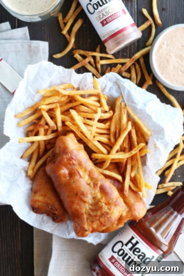 Crispy BBQ Beer Battered Fish and Chips served with lemon wedges and tartar sauce
