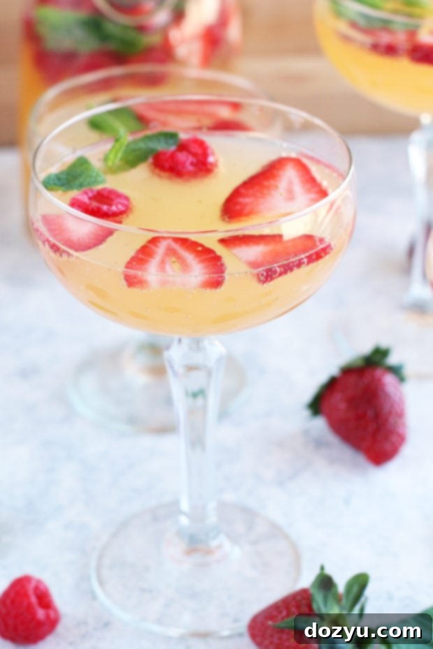 Effortless Bubbly Berry Sangria 5 A pitcher of Easy Champagne Sangria with fresh berries and mint, ready to be served.