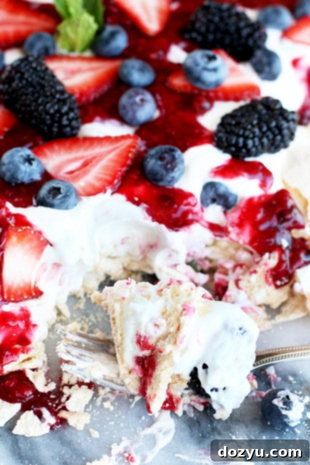 Crushed Berry Cloud Pavlova 7 Fork full of dessert with berries