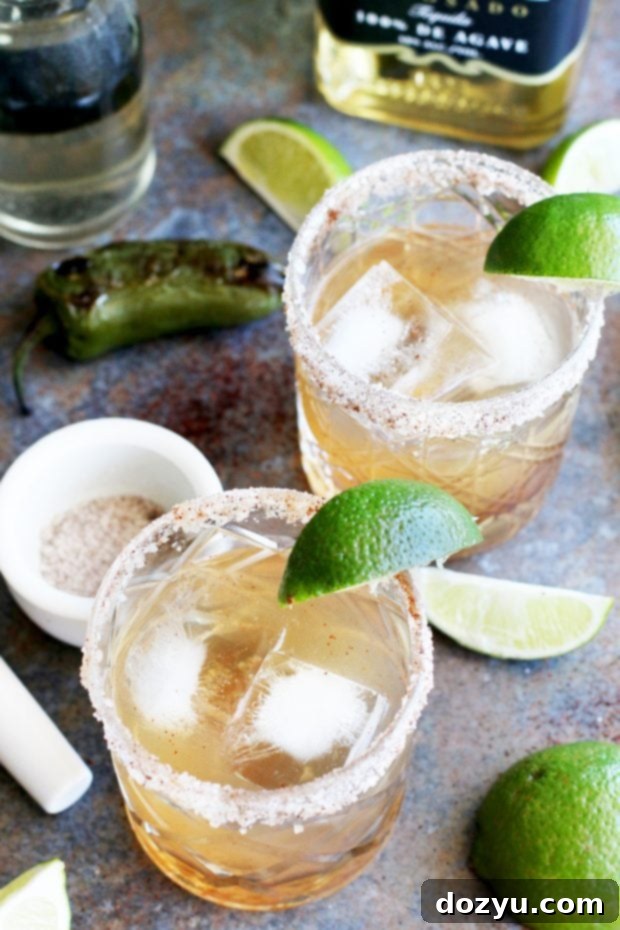 Smoldering Spice Margarita 2 Exquisite Smoky Jalapeño Margarita with a chili salt rim, garnished with a lime wedge