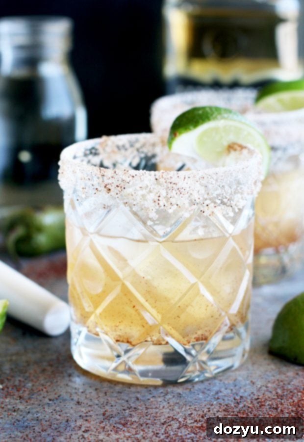Smoldering Spice Margarita 4 A close-up of a Smoky Jalapeño Margarita with a vibrant green lime slice