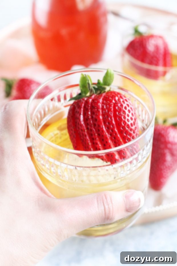 A Strawberry Rhubarb Old Fashioned with a view of a lake and mountains