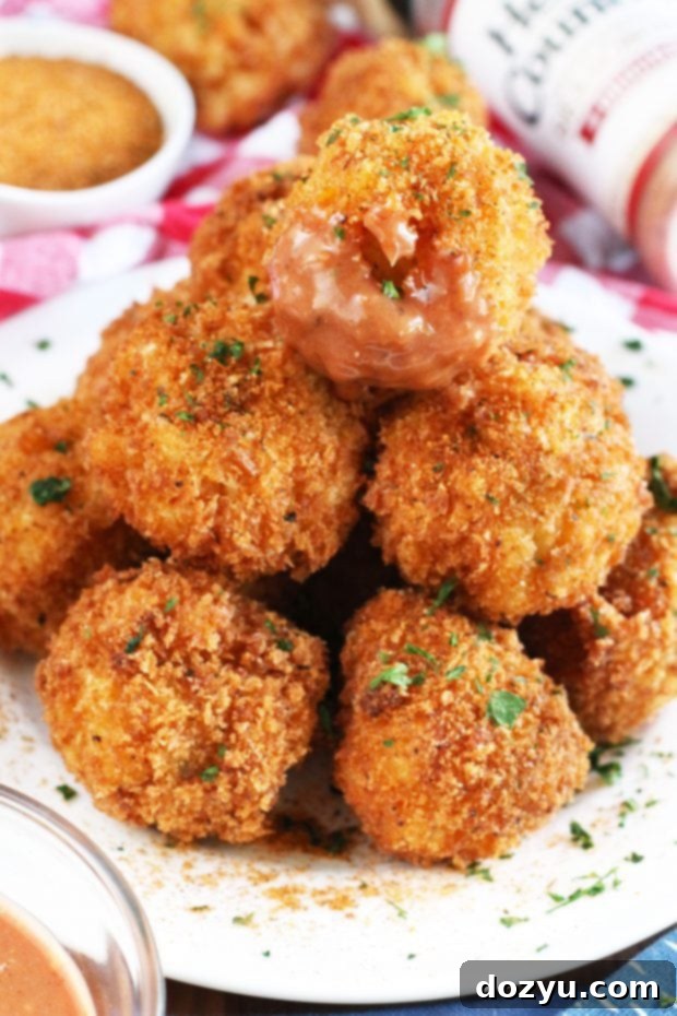BBQ Fried Mac & Cheese Balls 5 Cross-section of a BBQ Fried Mac N Cheese Ball, showing the creamy mac and cheese interior.