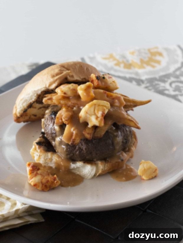 Epic Poutine Burger 2 A close-up shot of a Poutine Burger, showcasing the melted cheese curds, savory gravy, and crispy fries on a beef patty.