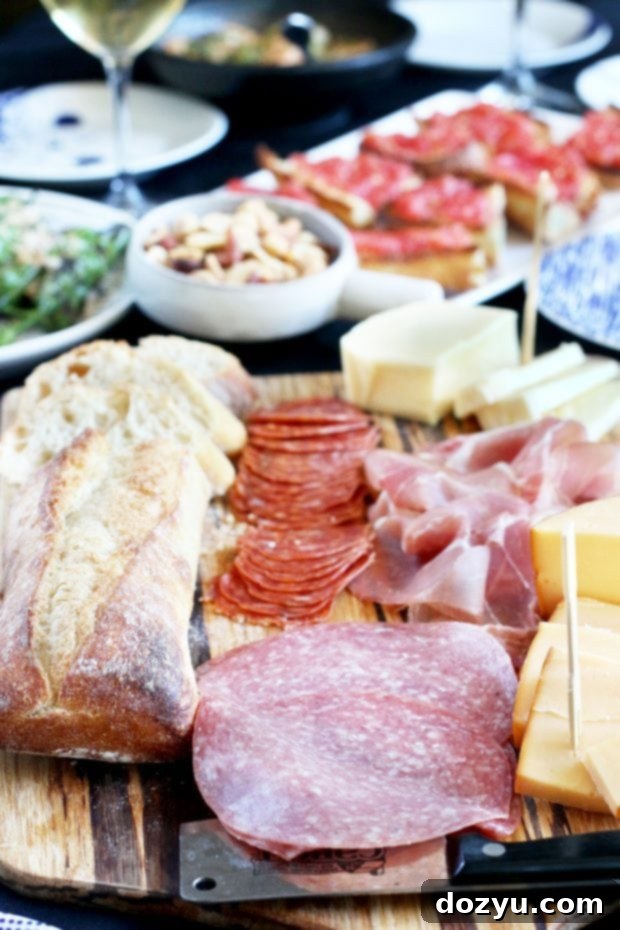 Beginning Your Tapas Bash From Scratch 7 A generously filled charcuterie board with various cheeses, cured meats, fruits, and crackers