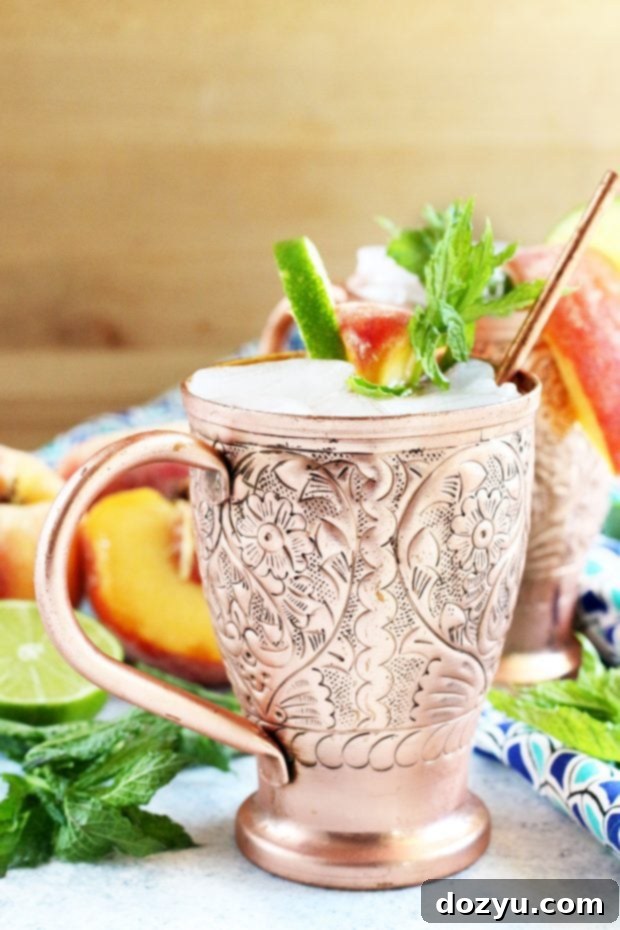 Close-up of a Peach Mint Moscow Mule with fresh ingredients