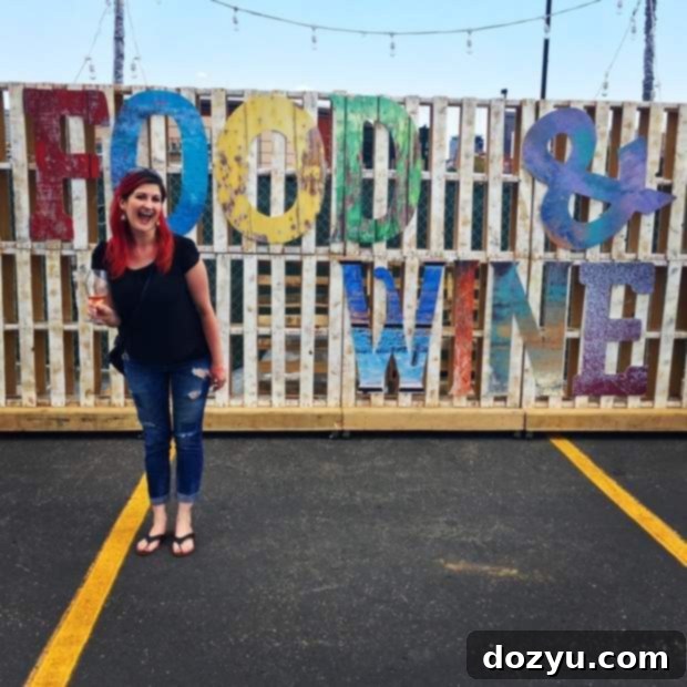An overhead view of the bustling Grand Tasting hall at the Denver Food + Wine Festival, featuring numerous vendor booths.
