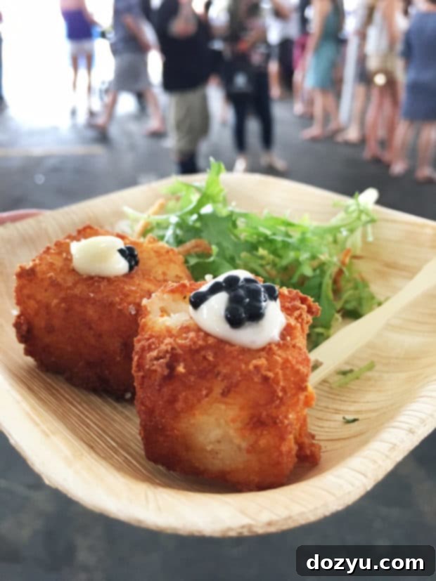 Close-up of a wine glass being poured at the Denver Food + Wine Grand Tasting, highlighting the extensive wine selection.