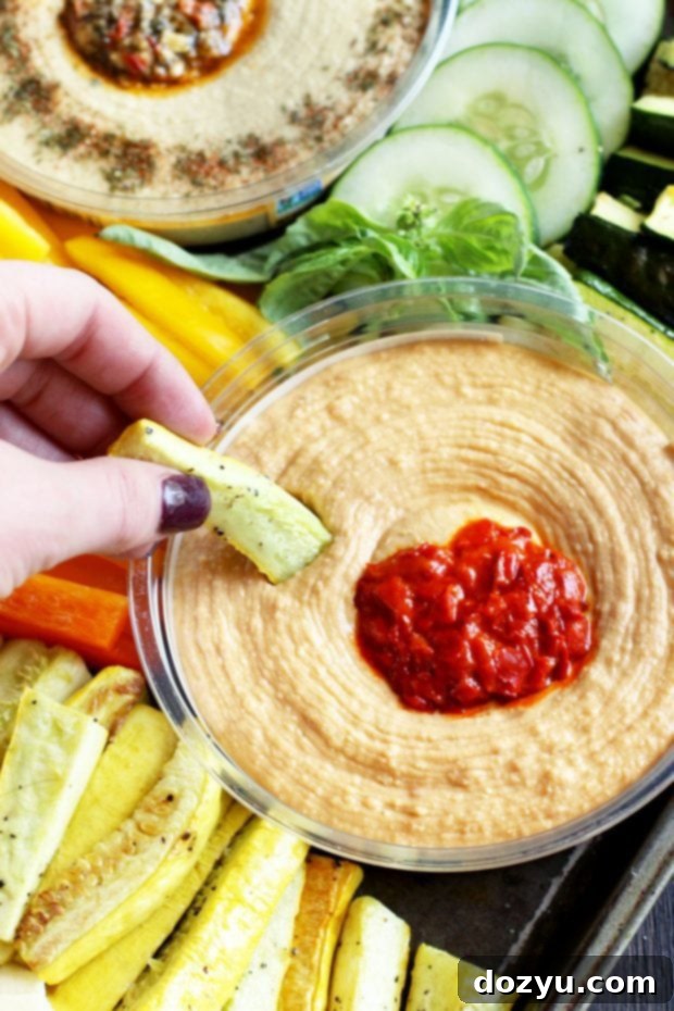 Close-up of a Summer Garden Vegetable Hummus Board with roasted zucchini and tomatoes