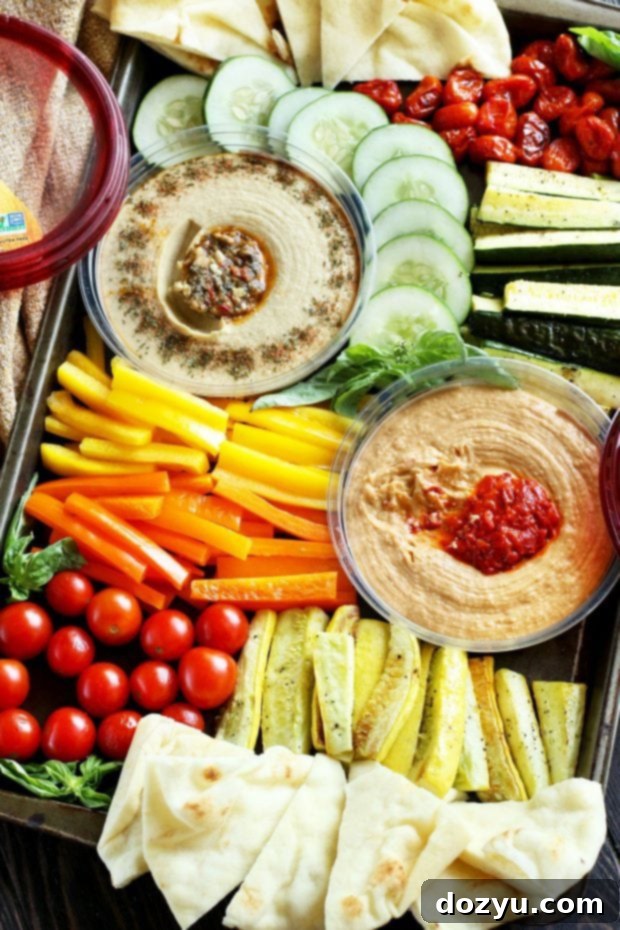 Overhead shot of a meticulously arranged Summer Garden Vegetable Hummus Board