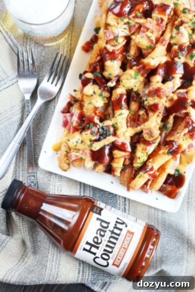 Addictive BBQ Bacon Fries 5 Crispy golden beer-battered fries served on a white platter