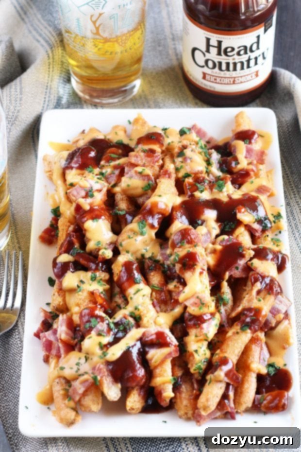 Addictive BBQ Bacon Fries 8 A platter of BBQ Bacon Crack Fries being held, ready to be served