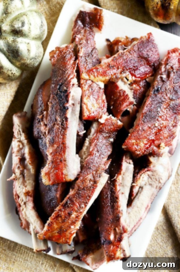 Platter of perfectly grilled Pumpkin Spice Dry Rub Ribs, ready to be carved