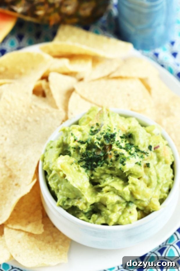 Freshly made Tropical Guacamole with a variety of colorful tortilla chips