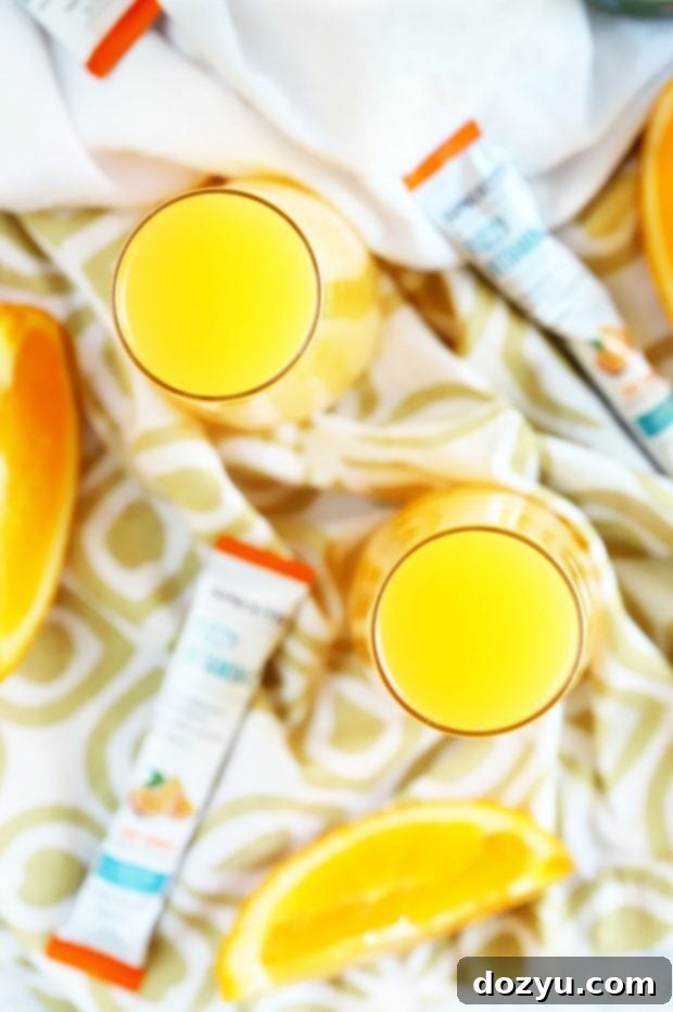 Serving a Tropical Mimosa Mocktail in a tall glass, garnished with fruit.