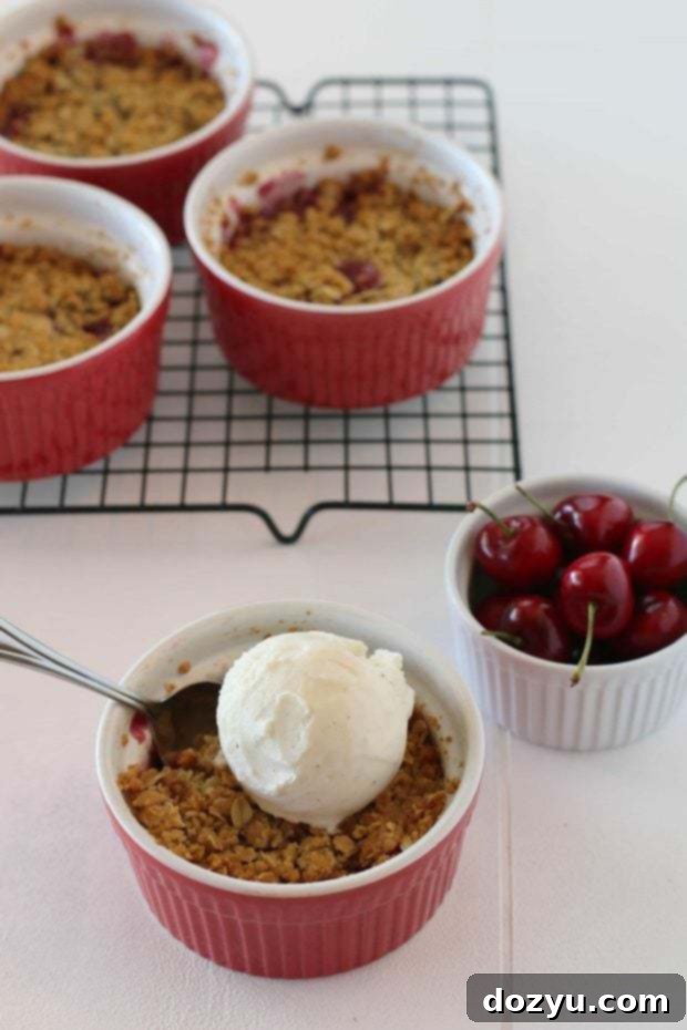 Single-Serving White Chocolate Cherry Crisps 2 Delicious individual white chocolate cherry crisps with a golden-brown topping.