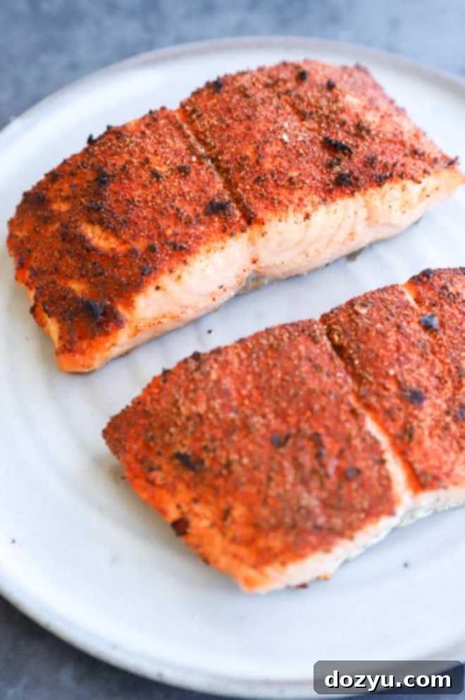 Elevated Salmon Sandwich with Herbed Dill Cream 8 Perfectly broiled salmon fillets, golden brown and flaky, presented on a plate