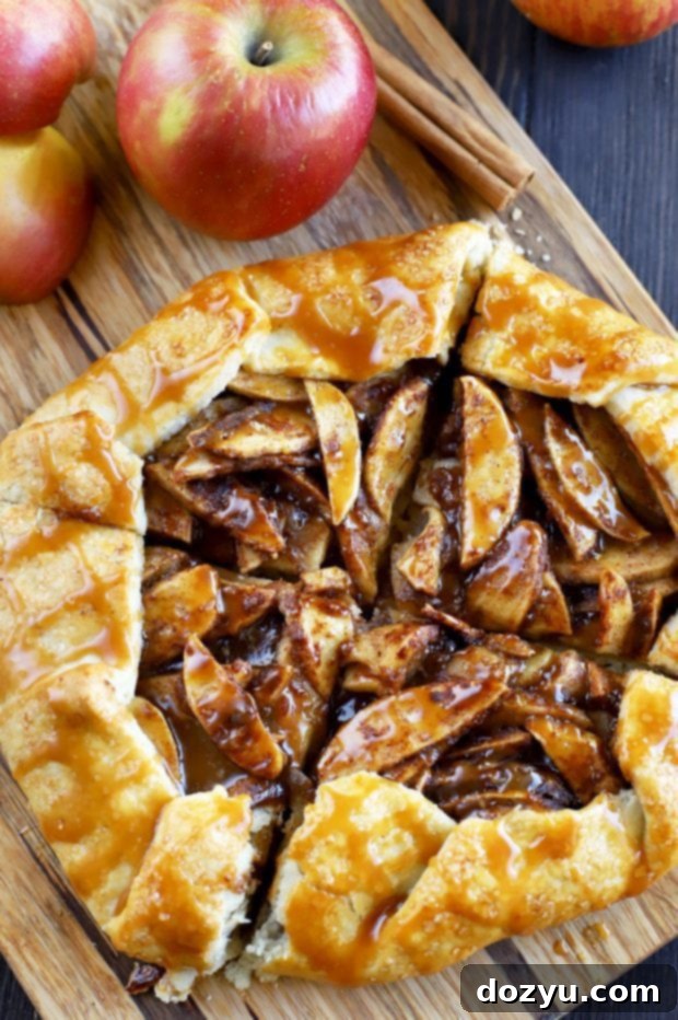 Bourbon-Kissed Caramel Apple Galette 9 Finished Bourbon Caramel Apple Galette on a cutting board, ready to be sliced
