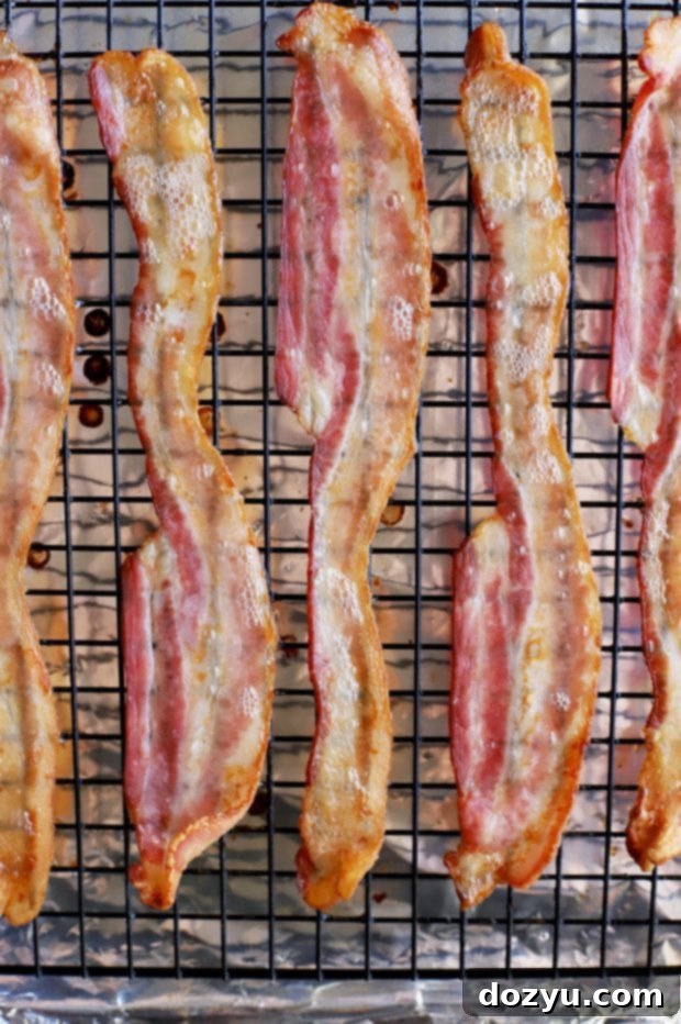 Golden Brie & Bacon Bites 5 A tray of unbaked Bite-Sized Baked Bacon Brie Pockets, brushed with egg wash and ready for the oven