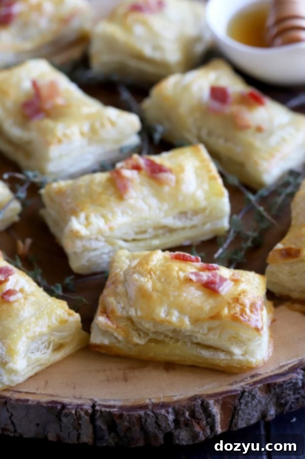 Golden Brie & Bacon Bites 8 A close-up shot of the flaky puff pastry before baking, showing the individual pockets shaped and ready