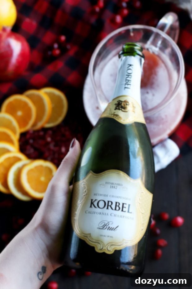 Two glasses of Sparkling Holiday Brunch Punch, showcasing the vibrant color and festive garnishes.